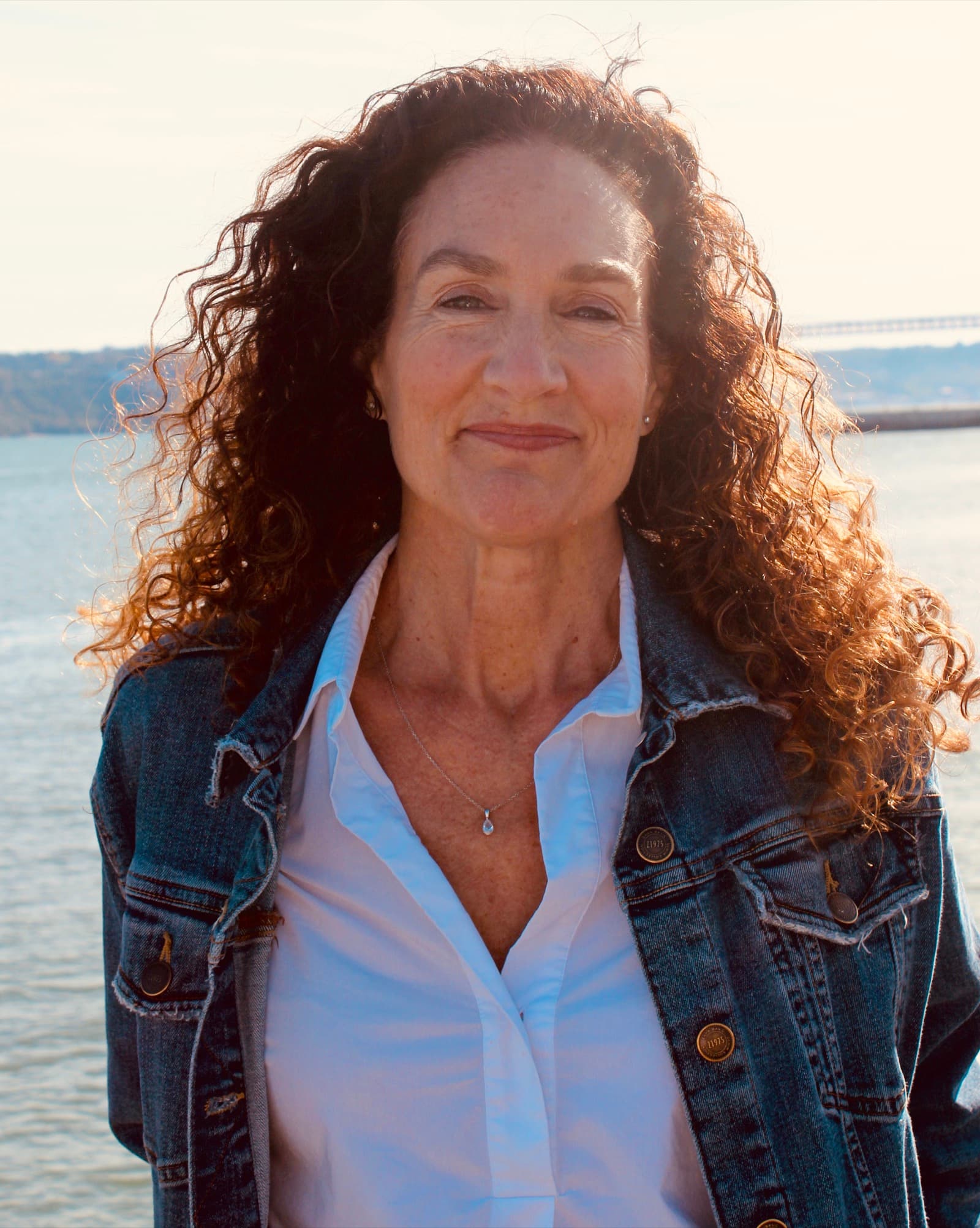Wendy Claire Mangeant in a denim jacket by the water